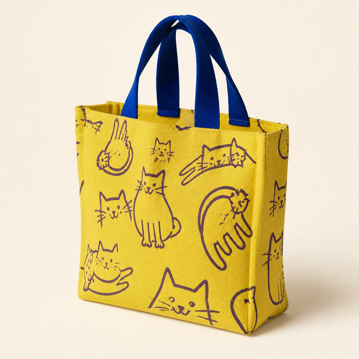 Acid-yellow mini tote with aubergine cat drawings and cobalt handles